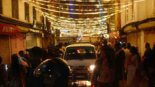crowded street decorated with lights.2b203e6a