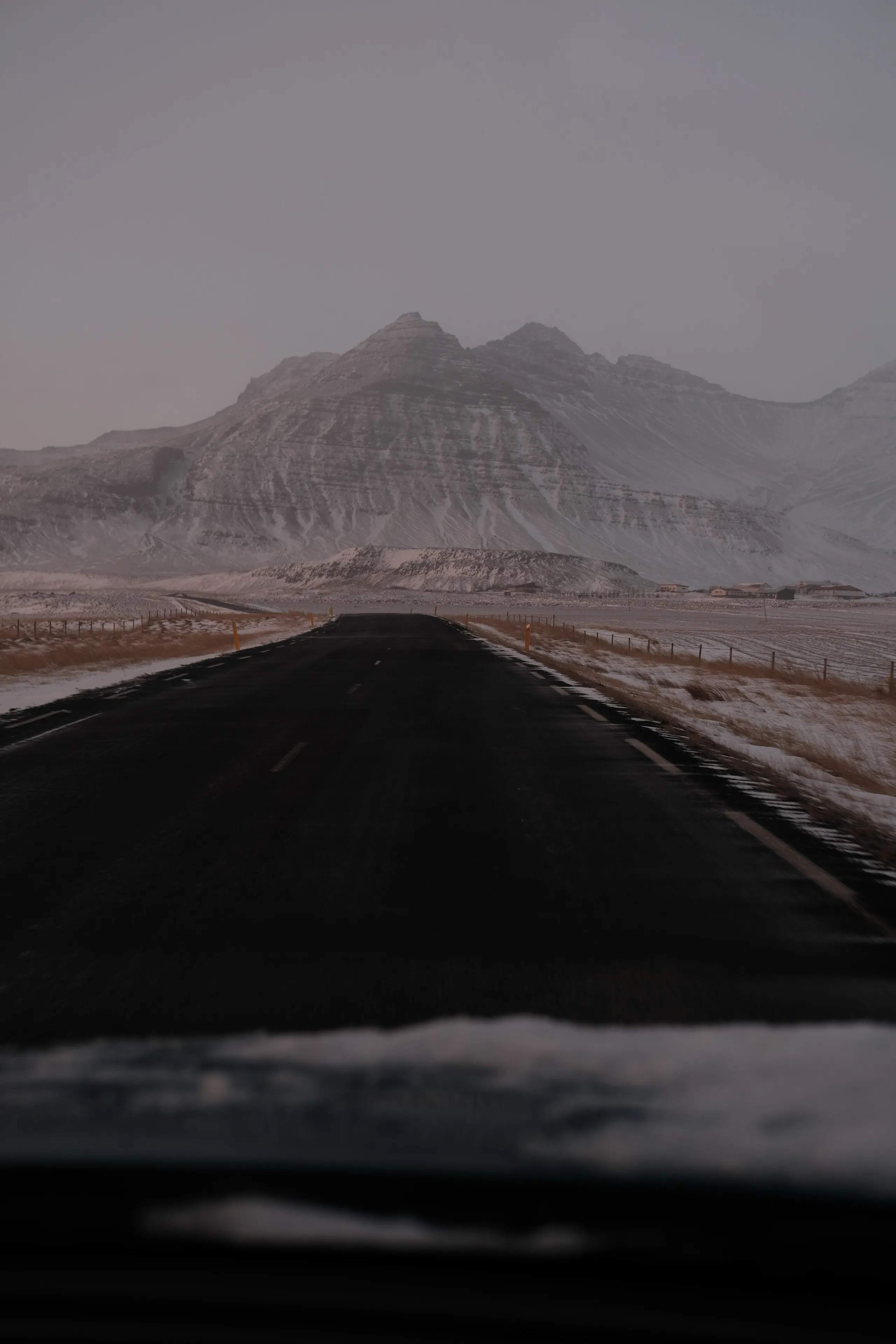 twilight road leading to snow covered mountain.2bd41593