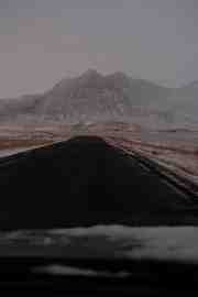 twilight road leading to snow covered mountain.2bd41593