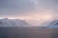 white snowy mountains with a lake in the foreground iceland.17763266